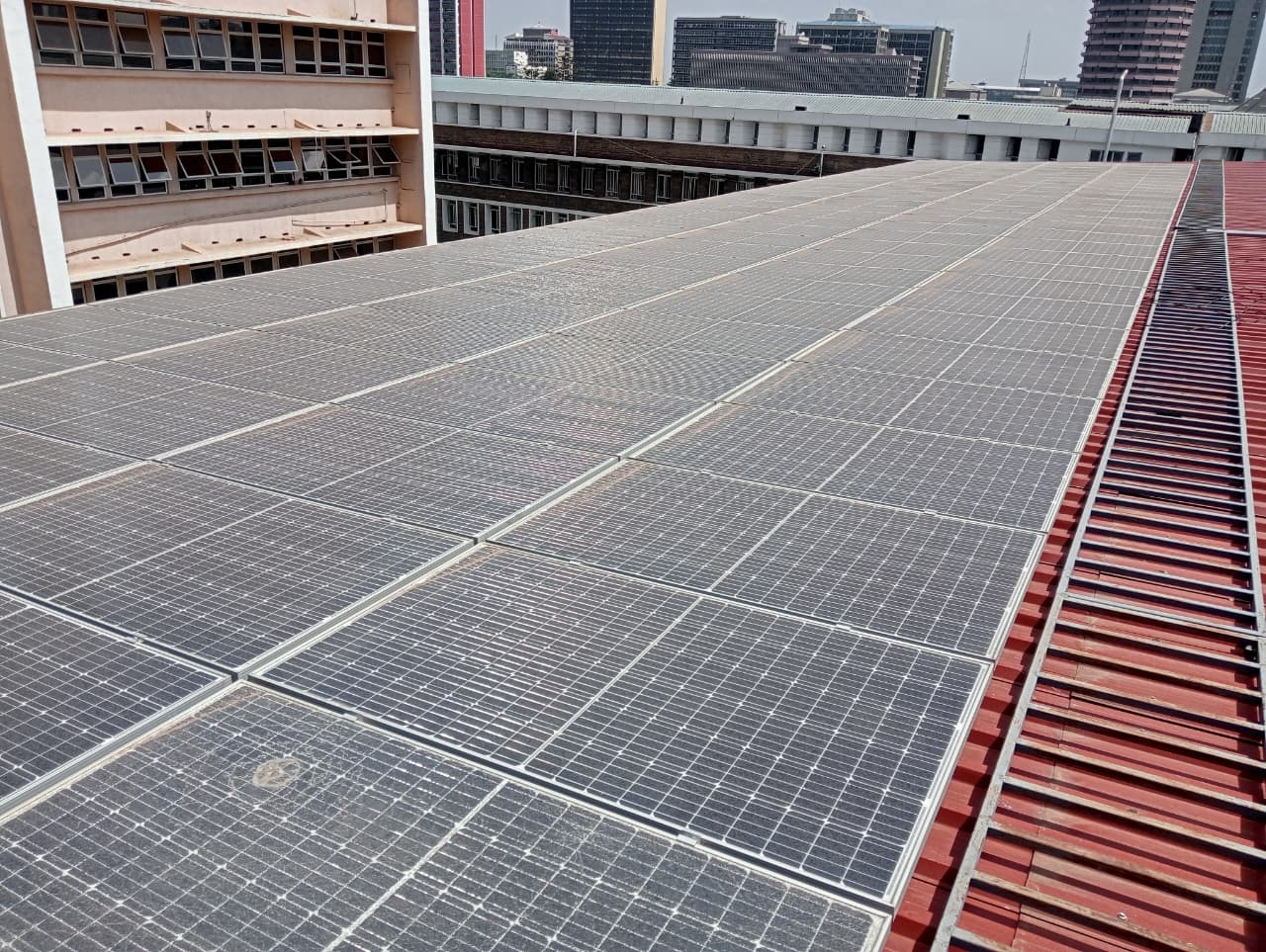 Large-scale solar panel array spanning a commercial roof in Nairobi, Kenya